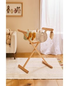 an ironing board with baby shoes hanging on it's clothesline in a living room