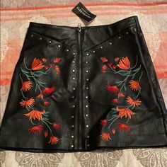 Black Leather Skirt With Flower Embroidery Black Embroidered Skirt, Chic Black Skirt With Floral Embroidery, Embroidered Black Mini Skirt For Spring, Chic Embroidered Black Skirt, Fitted Embroidered Black Mini Skirt, Goth Leather Skirt, Luxury Black Embroidered Skirt, Luxury Black Leather Mini Skirt, Black Leather Skirt