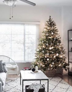 a living room with a christmas tree in the corner