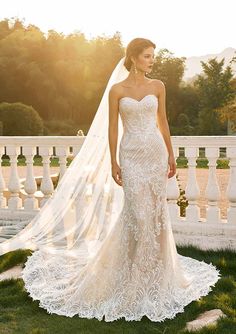 a woman in a wedding dress standing on the grass