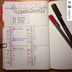 a doctor's appointment book is open with markers and pens on top of it