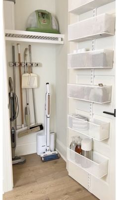 an organized closet with white shelving and cleaning supplies