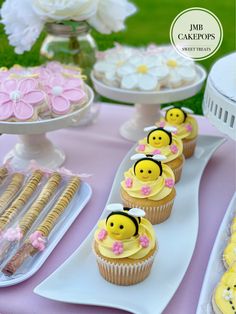 some cupcakes and cookies are on a table