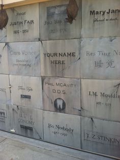 there are many names on the wall that is made out of cement blocks and concrete