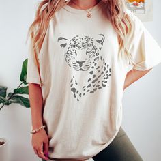 Introducing our fierce and fabulous Leopard Print Tee - the ultimate statement piece for the wild at heart! 🐆✨ Unleash your inner style predator with this trendy t-shirt adorned with a striking leopard print design. Crafted from high-quality cotton, it's as comfortable as it is stylish, making it a wardrobe essential for any fashion enthusiast. Pair it with your favorite jeans, a chic skirt, or layer it under a blazer for a versatile and on-trend ensemble. Embrace the untamed spirit of the wild with this eye-catching leopard print, a timeless pattern that never goes out of style. This is a Gildan Comfort Colors garment-dyed t-shirt.  The soft-washed, garment-dyed fabric brings extra coziness to your wardrobe while the relaxed fit makes it an excellent daily choice. The double-needle stitc Leopard Print T-shirt With Letter Print And Crew Neck, Trendy Cotton T-shirt In Leopard Print, Trendy Leopard Print Graphic T-shirt, Summer Short Sleeve T-shirt With Tiger Print, Leopard Print Relaxed Fit Short Sleeve Tops, Leopard Print Tops With Relaxed Fit And Short Sleeve, Leopard Print Short Sleeve Top With Relaxed Fit, Relaxed Fit Leopard Print Tops With Short Sleeves, Leopard Print Graphic Crew Neck Top