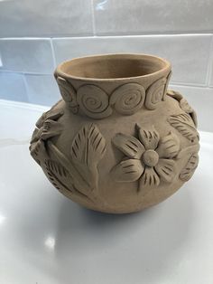 a clay vase sitting on top of a table