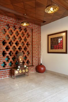 a living room with a brick wall and decorative artwork on the wall, along with two vases