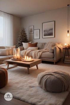 a living room filled with furniture and candles on the coffee table in front of a window