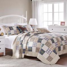 a white bed sitting next to a window in a bedroom on top of a hard wood floor