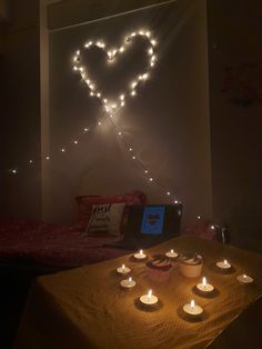 candles are lit in the shape of a heart