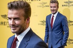 two men in suits standing next to each other on a red carpet with the words breitling behind them