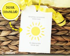 a yellow ribbon is attached to a white card that reads sending sunshine your way to brighten your day