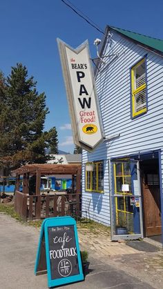 a blue building with a sign in front of it