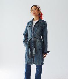 A stretchy, lightweight denim duster jacket, with a belted waist and faded wash.  By Armor Jeans.  Measures: Across Shoulders: 16" Chest: 40-42" Waist: 36" Length: 36" Sleeve: 25" Condition: Excellent.  FOLLOW US ON INSTAGRAM FOR DEALS AND SNEAK PEEKS! @Wildthingvintage instagram.com/wildthingvintage Twitter: @Wildthingpeck Message me any time for further details or questions. Please note there is a 10% restocking fee on orders cancelled prior to shipment. Returns are upon a case by case basis, Utility Style Denim Belted Outerwear, Utility Style Denim Outerwear With Belt, Utility Denim Outerwear With Belt, Utility Style Belted Denim Outerwear, Denim Utility Outerwear With Belt, Belted Denim Blue Denim Outerwear, Belted Long Sleeve Denim Jacket, Casual Denim Belted Outerwear, Casual Belted Denim Outerwear