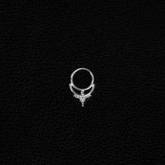 a silver ring on a black background