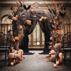 an outdoor ceremony setup with candles and pumpkins on the ground, decorated in black