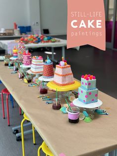 a long table with cakes and cupcakes on it