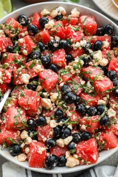 watermelon salad with blueberries and walnuts in a bowl on a table