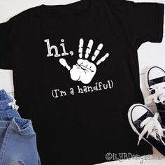 Hi five! It's your 5th birthday! Celebrate this milestone birthday with a stylish Hi Five I'm a Handful Handprint Birthday t-shirt. SIZE: 2T 3T 4T 5/6 XS youth S youth M youth L youth XL youth T-SHIRT COLOR: red navy black LETTER COLOR: white MATERIAL: 100% preshrunk cotton heat transfer vinyl CARE INSTRUCTIONS: DO NOT dry clean wash inside out in cold or warm water use mild detergents dry on low setting DO NOT iron directly onto design ••••••••••••••••••••••••••••••••••••••••••••••••••••••••••• Father's Day Black T-shirt With Funny Print, Family Matching Black Screen Print T-shirt, Black Family Matching T-shirt With Screen Print, Black T-shirt With Name Print For Family Matching, Black Family Matching T-shirt With Name Print, Black T-shirt With Name Print For Birthday, Casual Black T-shirt For Birthday, Black Top With Text Print For Birthday, Black Tops With Text Print For Birthday