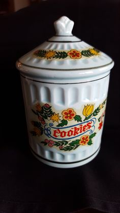 a white cookie jar sitting on top of a table