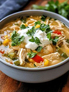 a white bowl filled with chicken and vegetable soup