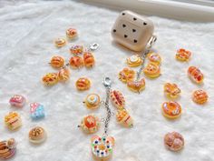 a collection of miniature donuts and dices on a white surface next to a window