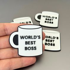 a hand holding a coffee mug with the words world's best boss on it