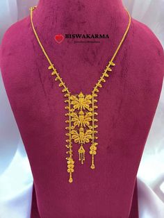 a gold necklace is displayed on a mannequin with the words biswakana