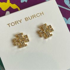 Elevate Your Style With These Stunning Tory Burch Kira Crystal Logo Stud Earrings In Gold. Perfect For A Mother's Day Gift, These Authentic Tory Burch Earrings Feature A Crystal Main Stone And A Post Closure For Easy Wear. The Elegant Stud Style And Feminine Design Make These Earrings Suitable For Any Occasion. Add These Earrings To Your Jewelry Collection And Make A Statement Wherever You Go. Tory Burch Earrings, Tory Burch Kira, Crystal Logo, Tory Burch Jewelry, Stud Style, Birthday Board, Earrings In Gold, Feminine Design, Dream Jewelry