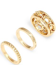 three gold rings with diamonds on each side and an open ring in the middle,