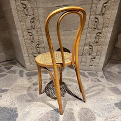 a wooden chair sitting on top of a stone floor