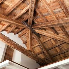 the inside of a building with wooden beams