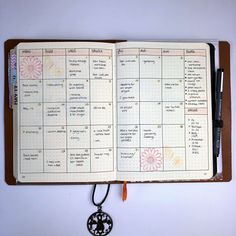 an open planner with a key hanging from it