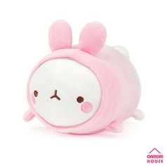 a pink stuffed animal with ears on it's head and eyes, sitting in front of a white background