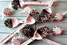 some candy canes and spoons on a table