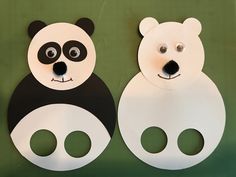 two paper panda and bear masks on green surface with black and white design, one is cut out to look like the other