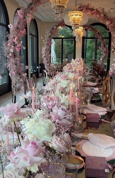 a long table with pink and white flowers on it