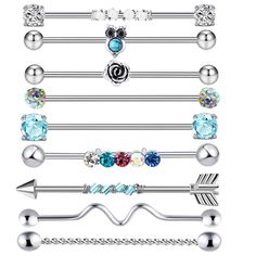 an assortment of different types of piercings on a white background, including balls and arrows