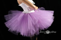 "Make a huge impression with this massive royalty peek a boo style tutu! This tutu is handmade from 35yards of soft smooth Bridal tulle in three layers of light purple that has been gathered and serged to the matching fabric covered elastic waistband. LENGTH 13\" long Measurement: Sizes go by smallest waist size tutu will fit to largest Hips tutu fits over Child size 20\"-30\"inches 12\" long (good for ages 4-13) Adult sizes Please go by your waist size not your hips. Tutu will have plenty of st Fitted Purple Petticoat For Party, Fitted Purple Tutu Dress For Costume, Purple Tulle Tutu Dress For Wedding, Fitted Lavender Tulle Tutu Dress, Lavender Princess Style Tutu Dress, Purple Fairy Style Tutu Dress, Fitted Lavender Princess Tutu Dress, Purple Fitted Tutu Dress With Ruffles, Fitted Princess Style Lavender Tutu Dress