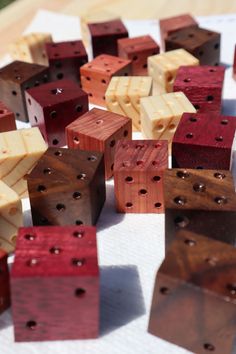 several pieces of wood that have been made to look like dices with holes in them