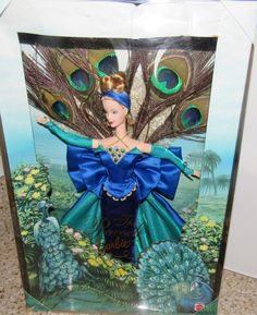 a barbie doll is in a box with peacocks on it's head and dress