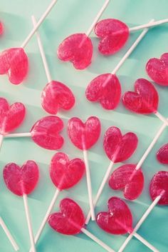 there are many heart shaped lollipops on the stick with the words i want candy