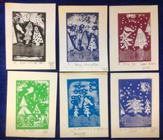 four different colored christmas cards on a blue surface