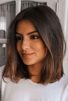 a close up of a person wearing a white t - shirt and looking at the camera