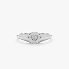 Kate Follow your heart, and it’ll lead you to our Signet Rings. This Signet ring is our modern take on the ever-so-classic ring. It's so delicate that it can even be worn on your pinky! Also, it would be a great gift for a new bride or a mommy. Shop our signet Ring Collection to celebrate all of the special people and moments of your life! - Handmade- Solid Gold- Natural Diamonds - G Color, SI Quality Diamonds- Total Diamond Carat Weight: 0.03 ctw- Ring Dimensions: 6 mm to 1.70 mm All pieces com