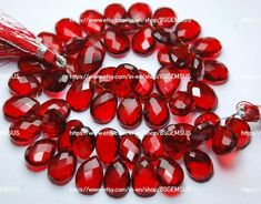 red glass beads with tassels on white background