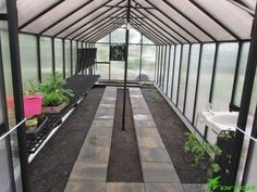 the inside of a greenhouse with plants growing in it