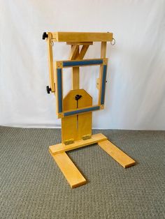 a small wooden machine with wheels on it