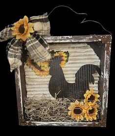 an old tin box with sunflowers and a scarecrow