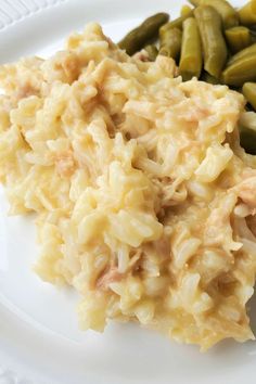 a white plate topped with mashed potatoes and green beans